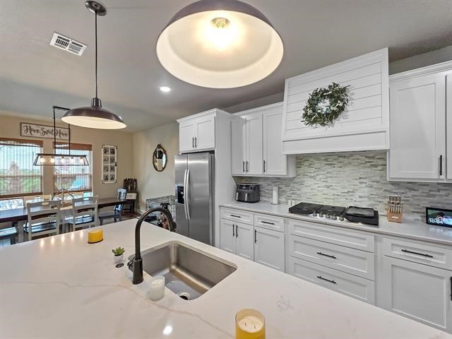14845 Norma Jane Lane Beaumont, TX 77713 - Photo 10 of 35 a kitchen with a sink a stove and cabinets