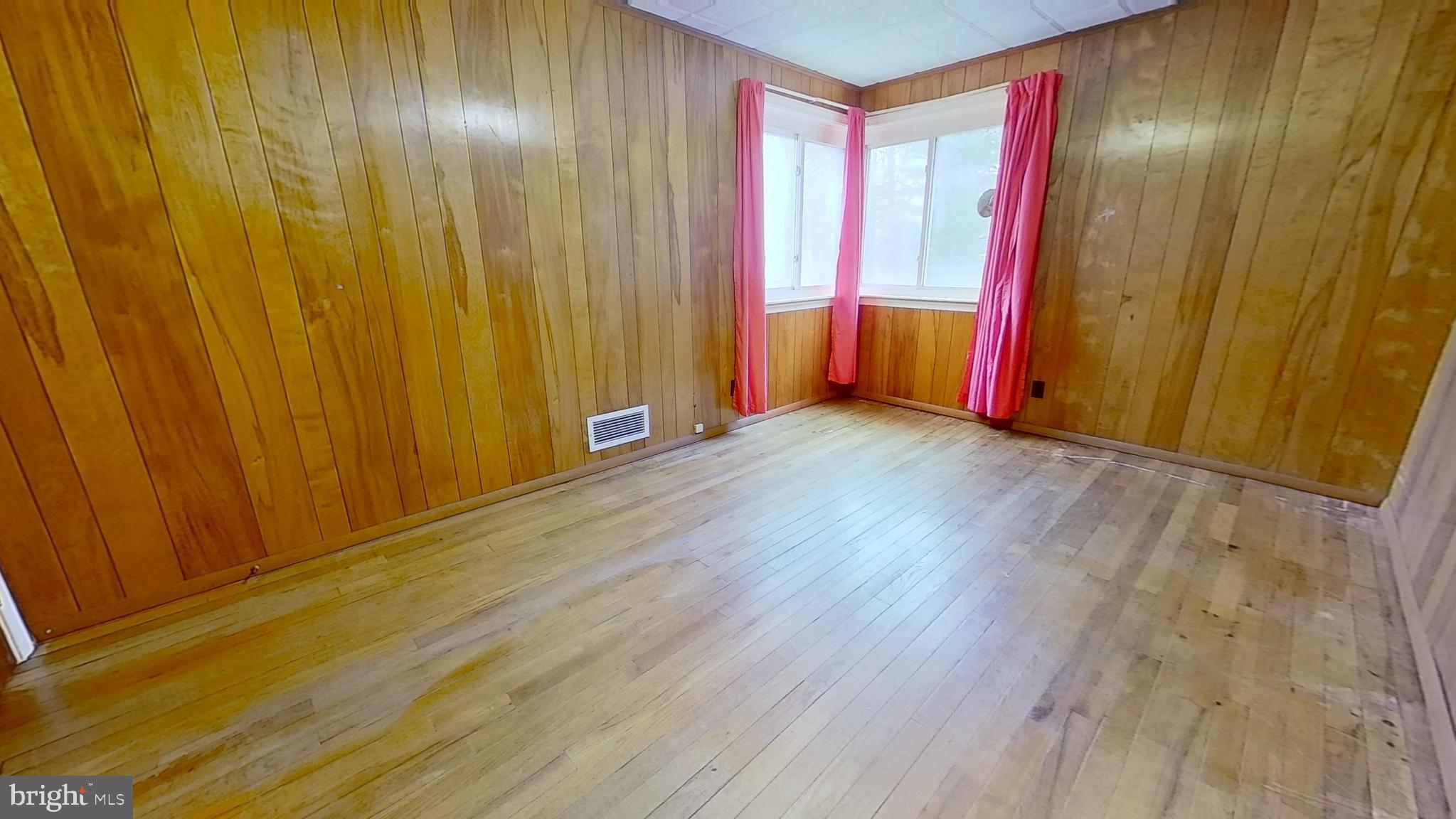 2821 South Queen Street Dallastown, PA 17313 - Photo 14 of 14 a view of an empty room with wooden floor and a window