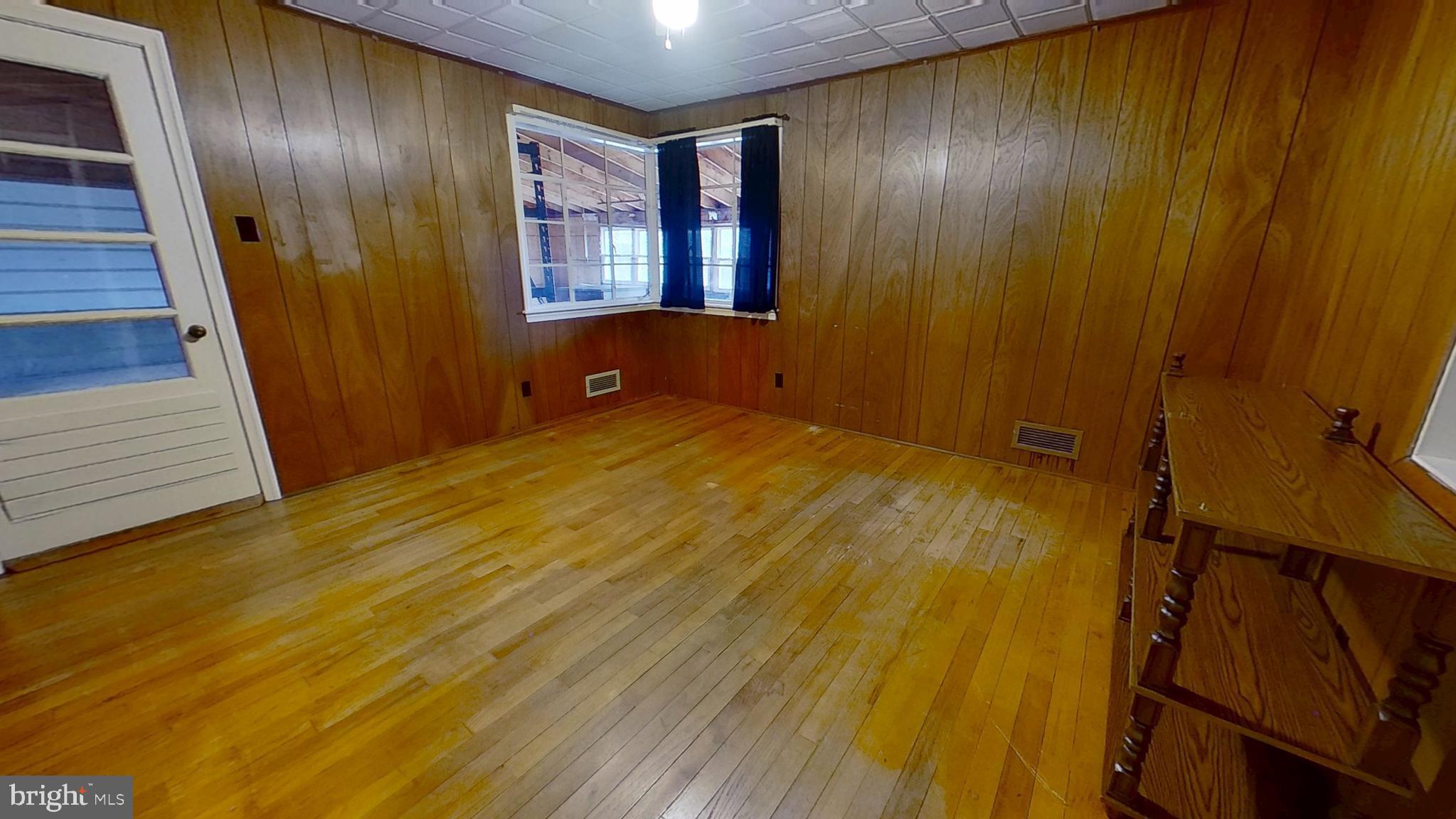 2821 South Queen Street Dallastown, PA 17313 - Photo 9 of 14 a view of an empty room with wooden floor and a window