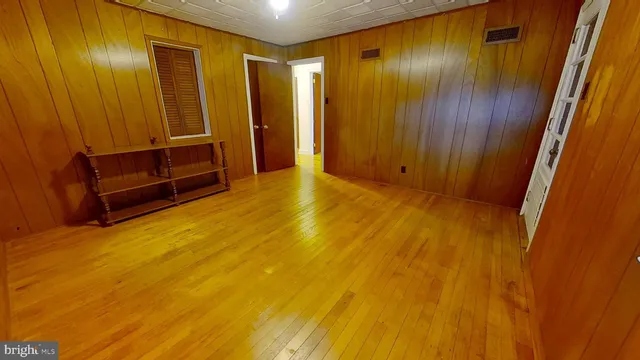 a view of an empty room with wooden door