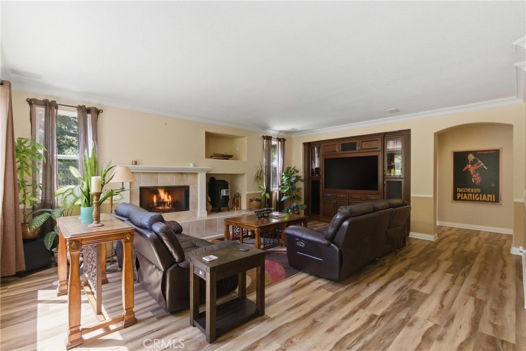25120 Southwind Court Stevenson Ranch, CA 91381 - Photo 11 of 41 a living room with furniture a flat screen tv and a fireplace