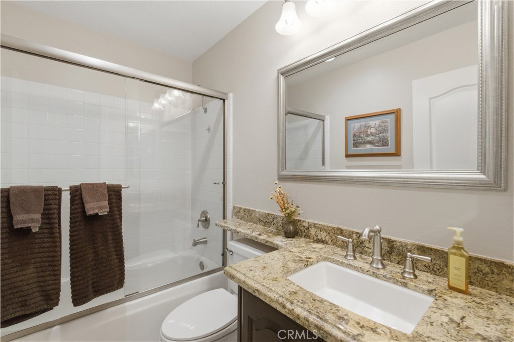 25120 Southwind Court Stevenson Ranch, CA 91381 - Photo 14 of 41 a bathroom with a granite countertop sink toilet and shower
