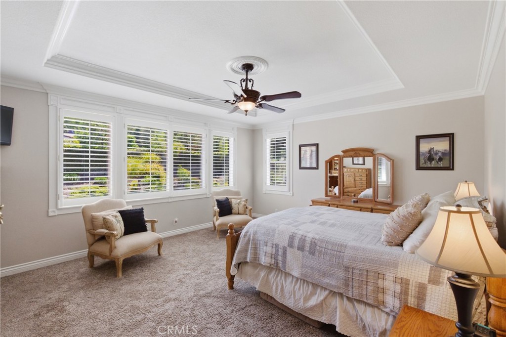 25120 Southwind Court Stevenson Ranch, CA 91381 - Photo 17 of 41 a bedroom with a bed and a chandelier