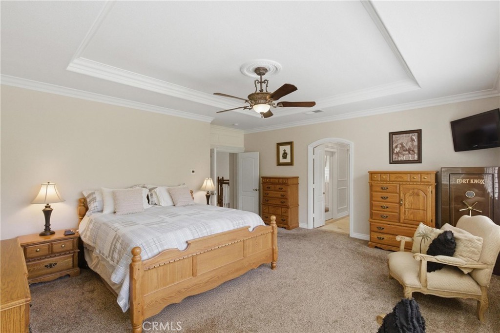 25120 Southwind Court Stevenson Ranch, CA 91381 - Photo 18 of 41 a bedroom with a bed and ceiling fan