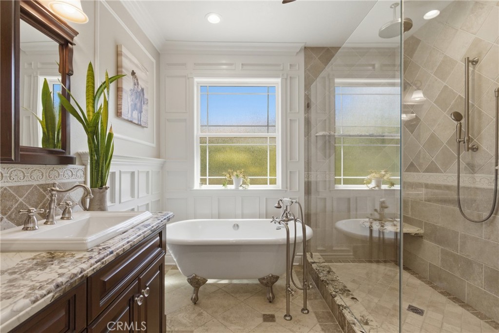 25120 Southwind Court Stevenson Ranch, CA 91381 - Photo 20 of 41 a bathroom with a granite countertop sink a mirror and a shower