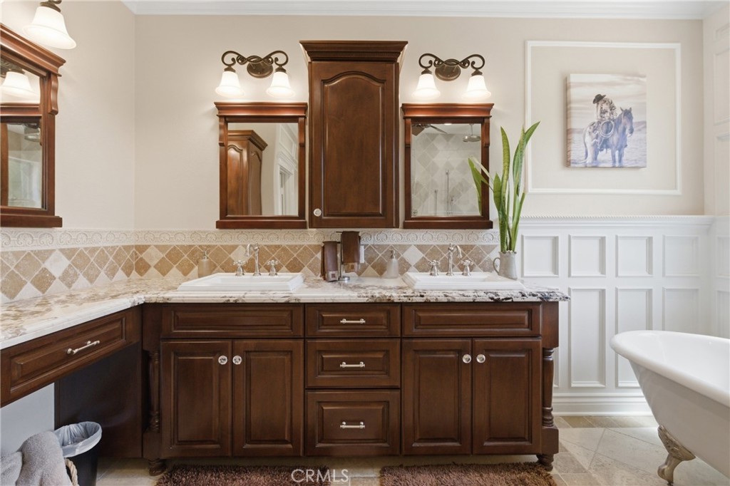 25120 Southwind Court Stevenson Ranch, CA 91381 - Photo 21 of 41 a bathroom with a granite countertop sink and a mirror