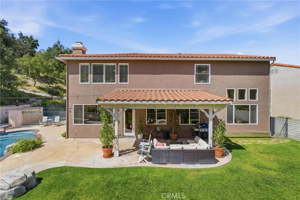 25120 Southwind Court Stevenson Ranch, CA 91381 - Photo 33 of 41 a view of a house with a yard and sitting area