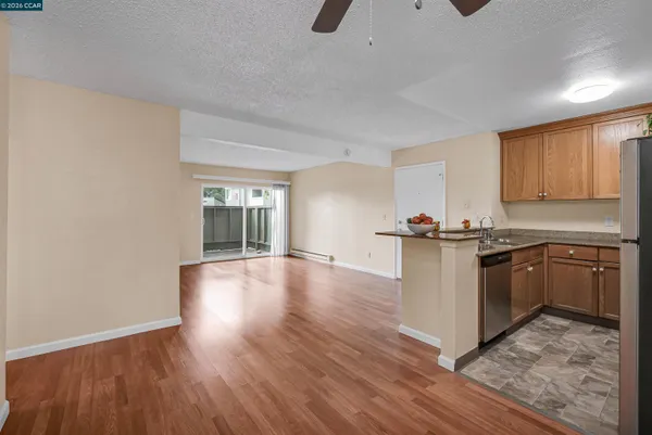 a kitchen with granite countertop a stove and a wooden floors
