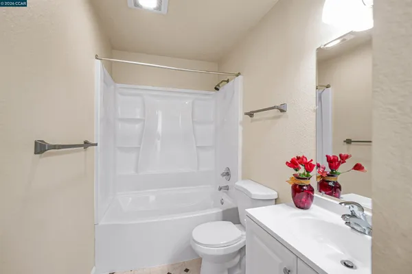 a bathroom with a sink mirror toilet and bathtub