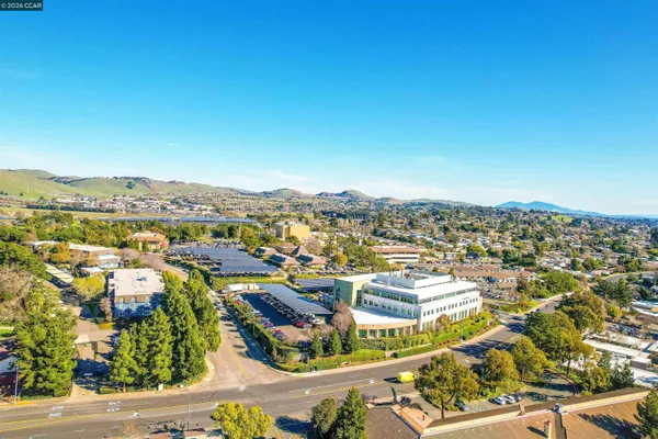 an aerial view of residential houses with outdoor space