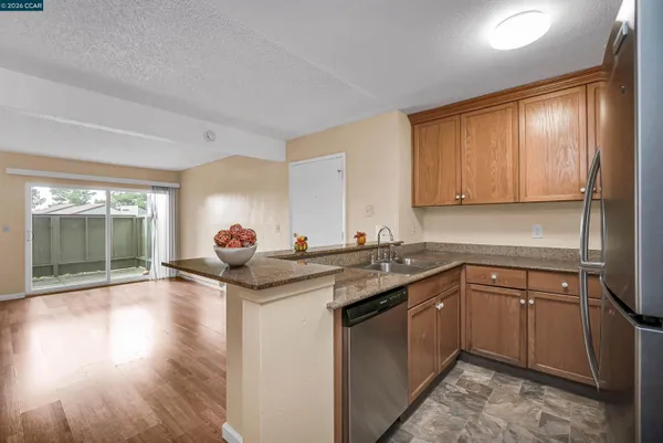 a kitchen with stainless steel appliances granite countertop a sink and cabinets