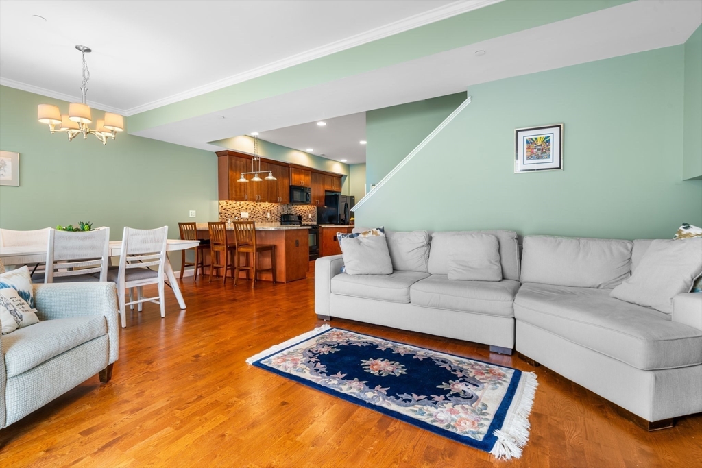 170 Beach Road, Unit 40 Salisbury, MA 01952 - Photo 8 of 32 a living room with furniture a rug and a chandelier