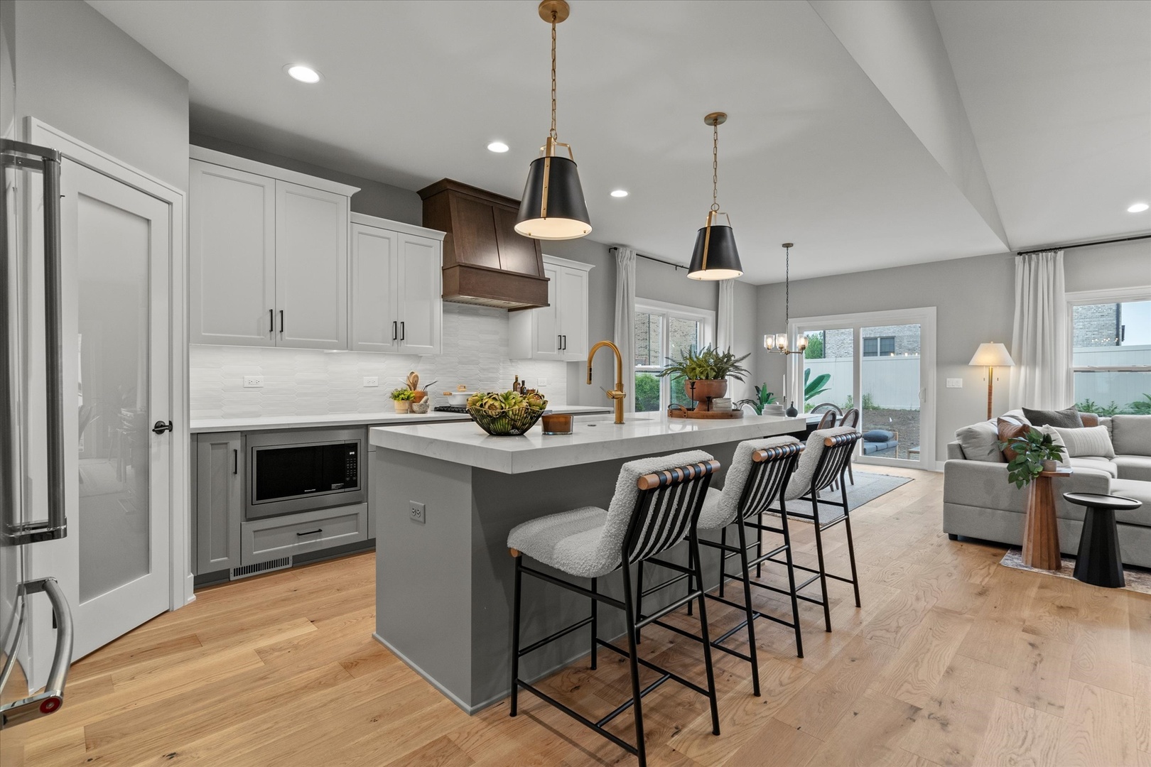 16580 Kayla Drive Lemont, IL 60439 - Photo 15 of 47 a kitchen with stainless steel appliances granite countertop a stove top oven a refrigerator a sink and a dining table with wooden floor