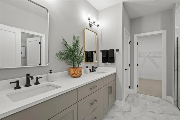 a bathroom with double sink and a mirror