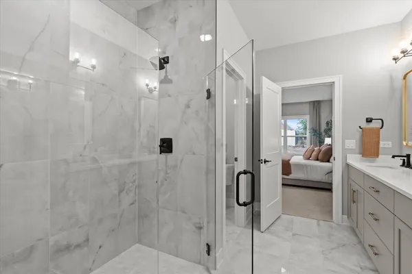 a en suite bathroom with a granite countertop sink a toilet and shower