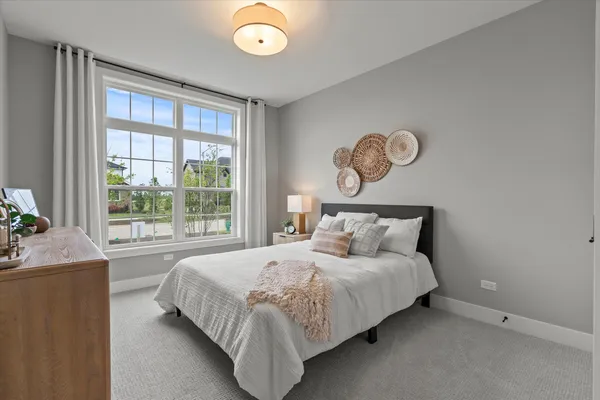 a bedroom with a large bed and a large window