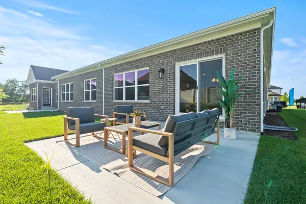 a view of a house with swimming pool and porch with furniture
