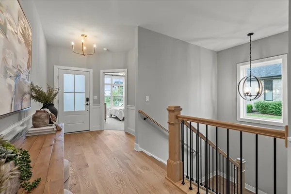 a view of a livingroom with furniture wooden floor and a chandelier