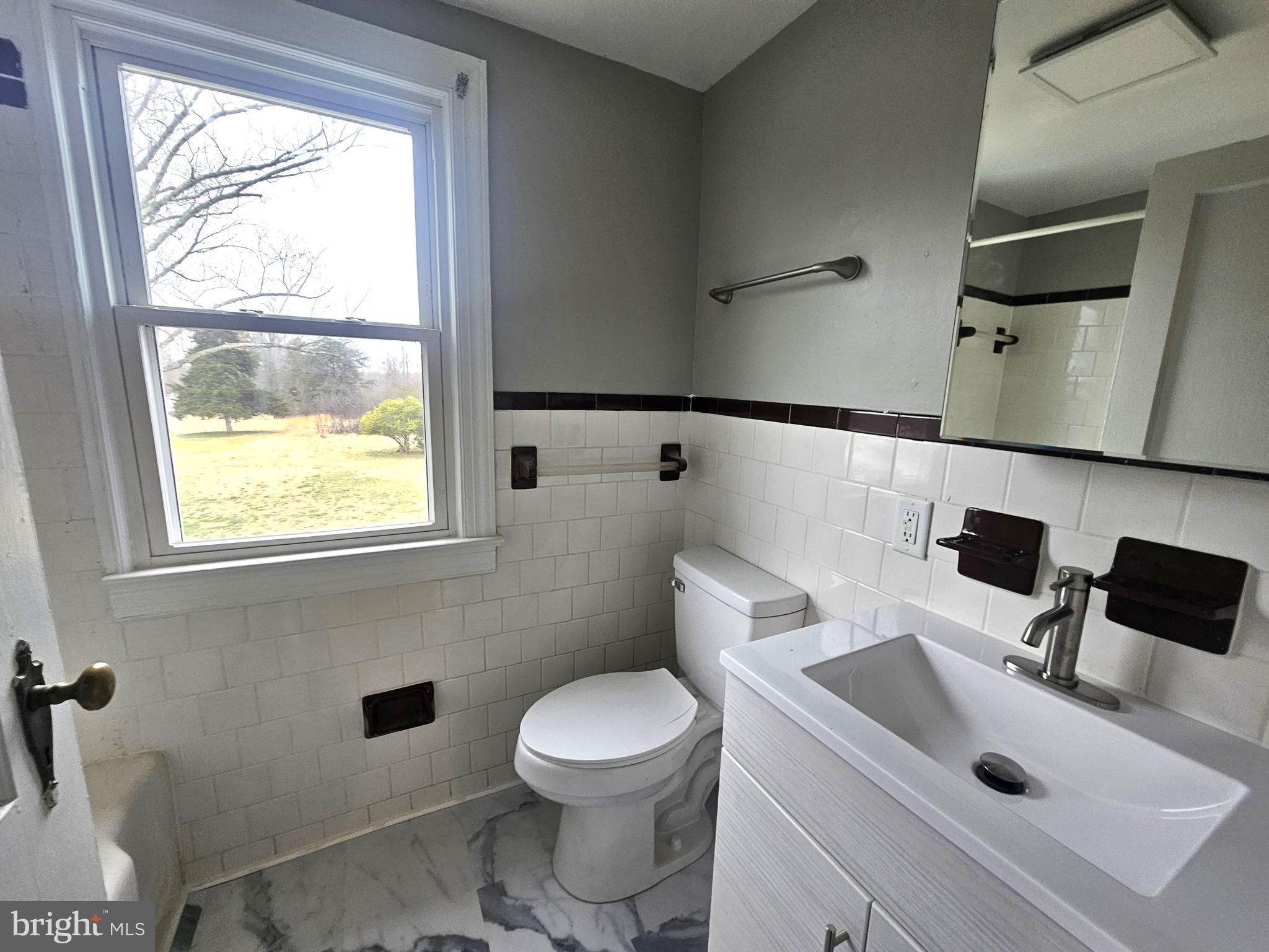 1431 Warrenton Road Fredericksburg, VA 22406 - Photo 13 of 25 a bathroom with a sink a toilet and a window