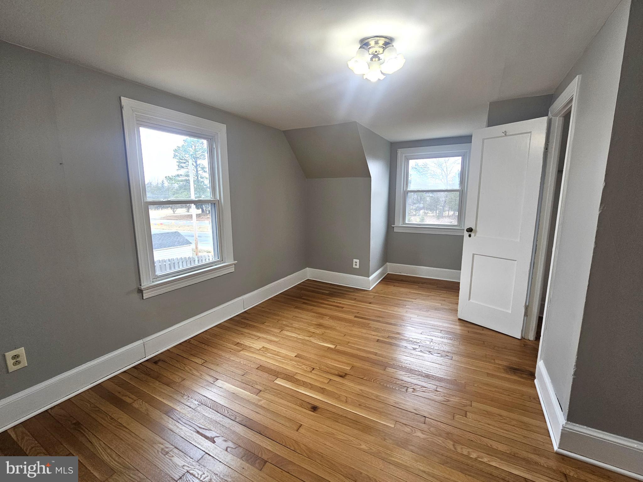 1431 Warrenton Road Fredericksburg, VA 22406 - Photo 14 of 25 an empty room with wooden floor and windows