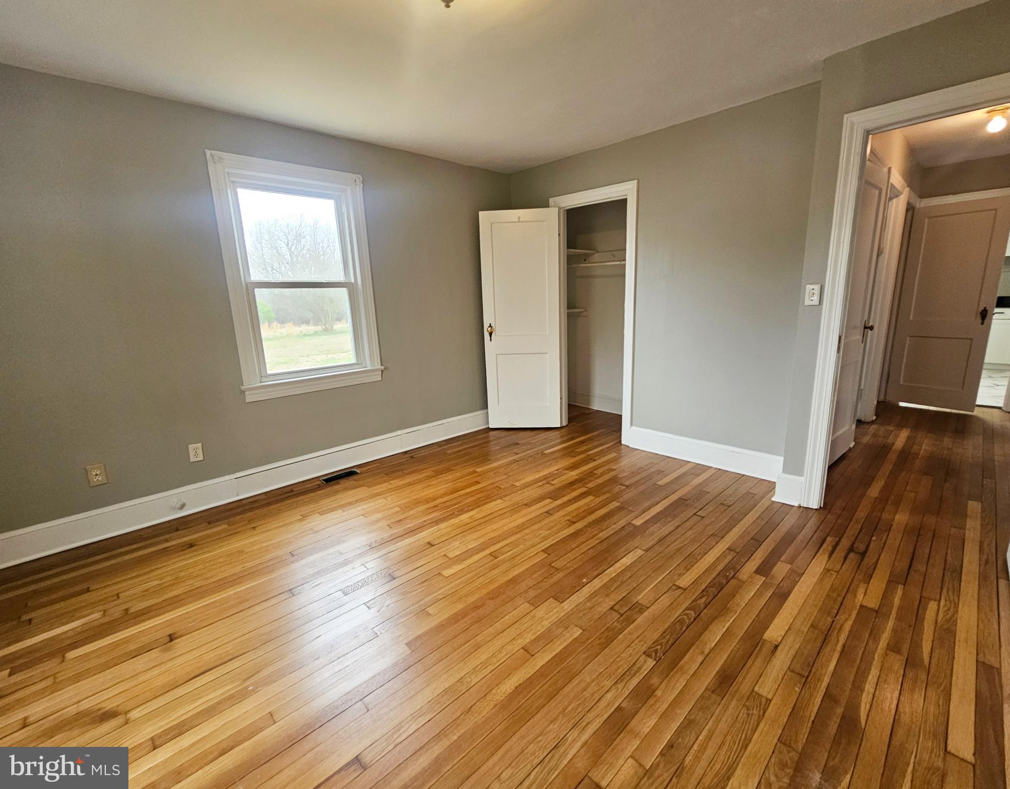 1431 Warrenton Road Fredericksburg, VA 22406 - Photo 16 of 25 an empty room with wooden floor and windows