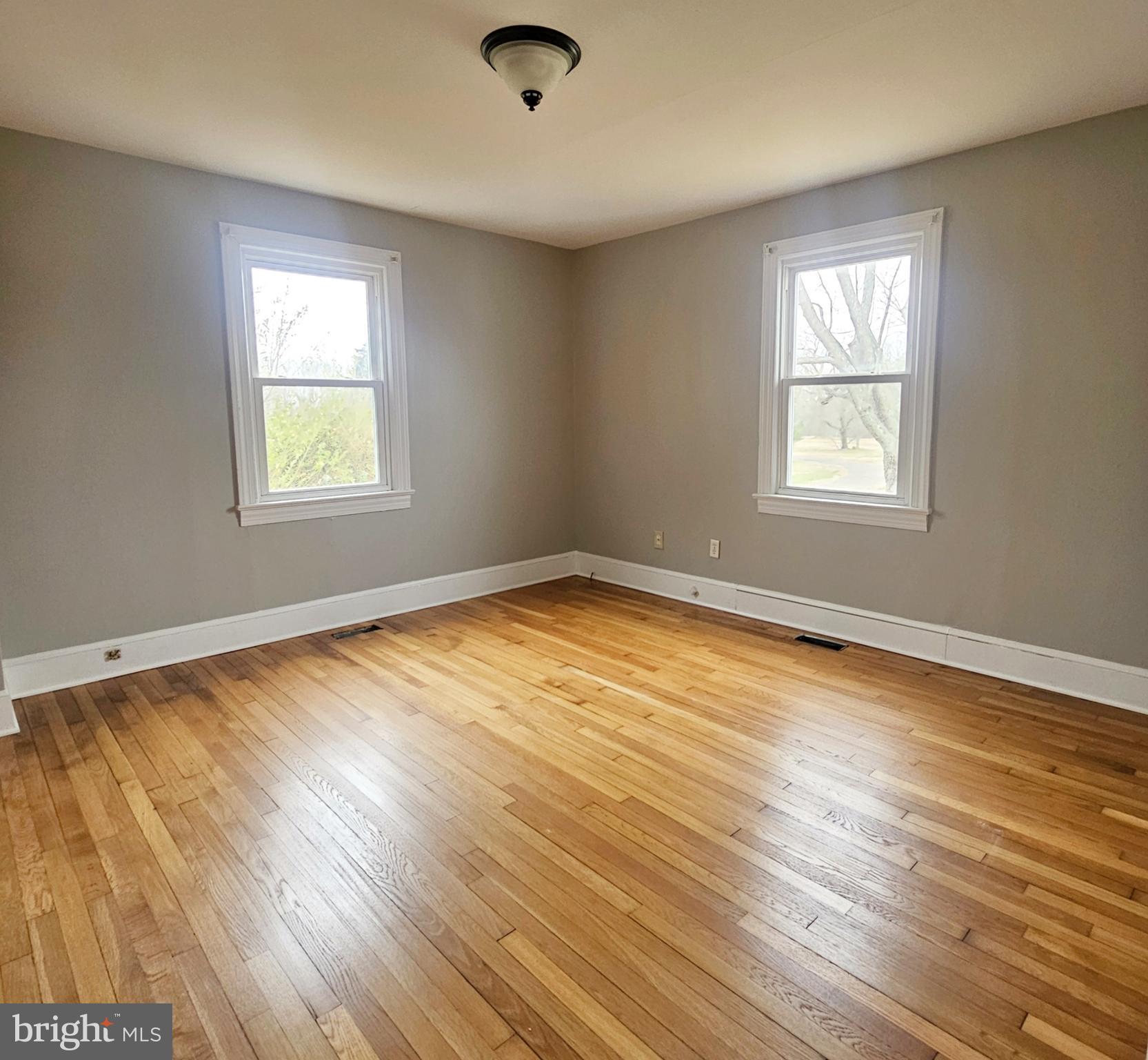 1431 Warrenton Road Fredericksburg, VA 22406 - Photo 17 of 25 a view of an empty room with wooden floor and a window
