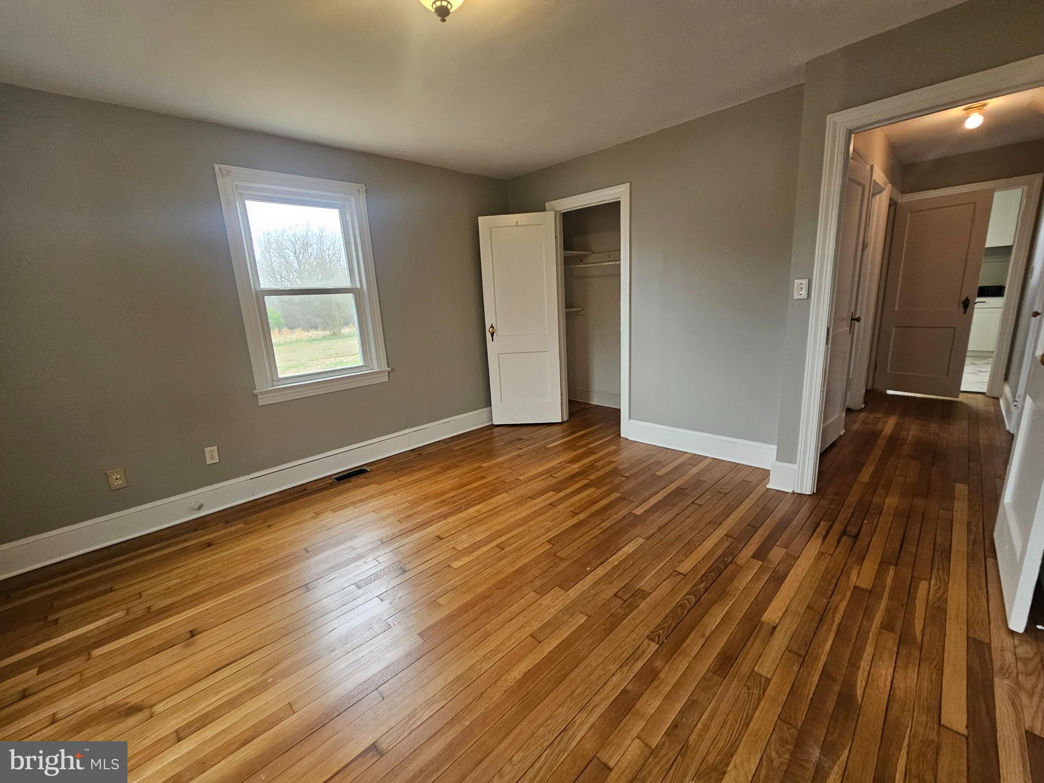 1431 Warrenton Road Fredericksburg, VA 22406 - Photo 18 of 25 a view of an empty room with wooden floor and a window