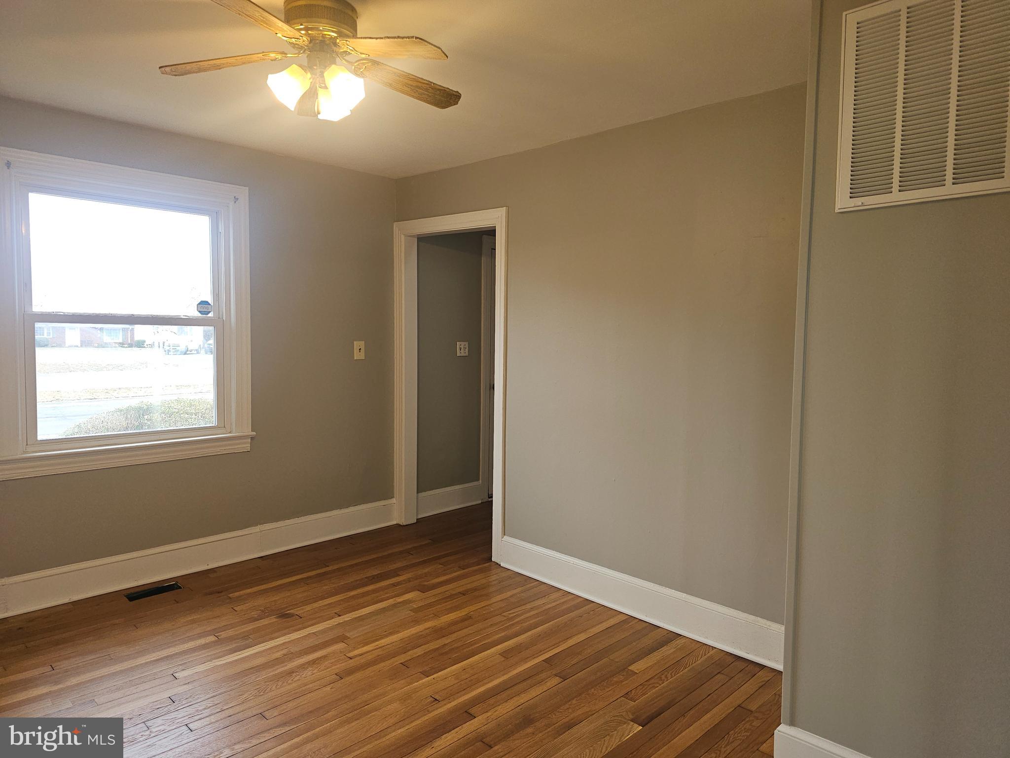1431 Warrenton Road Fredericksburg, VA 22406 - Photo 19 of 25 a view of an empty room with wooden floor and a window
