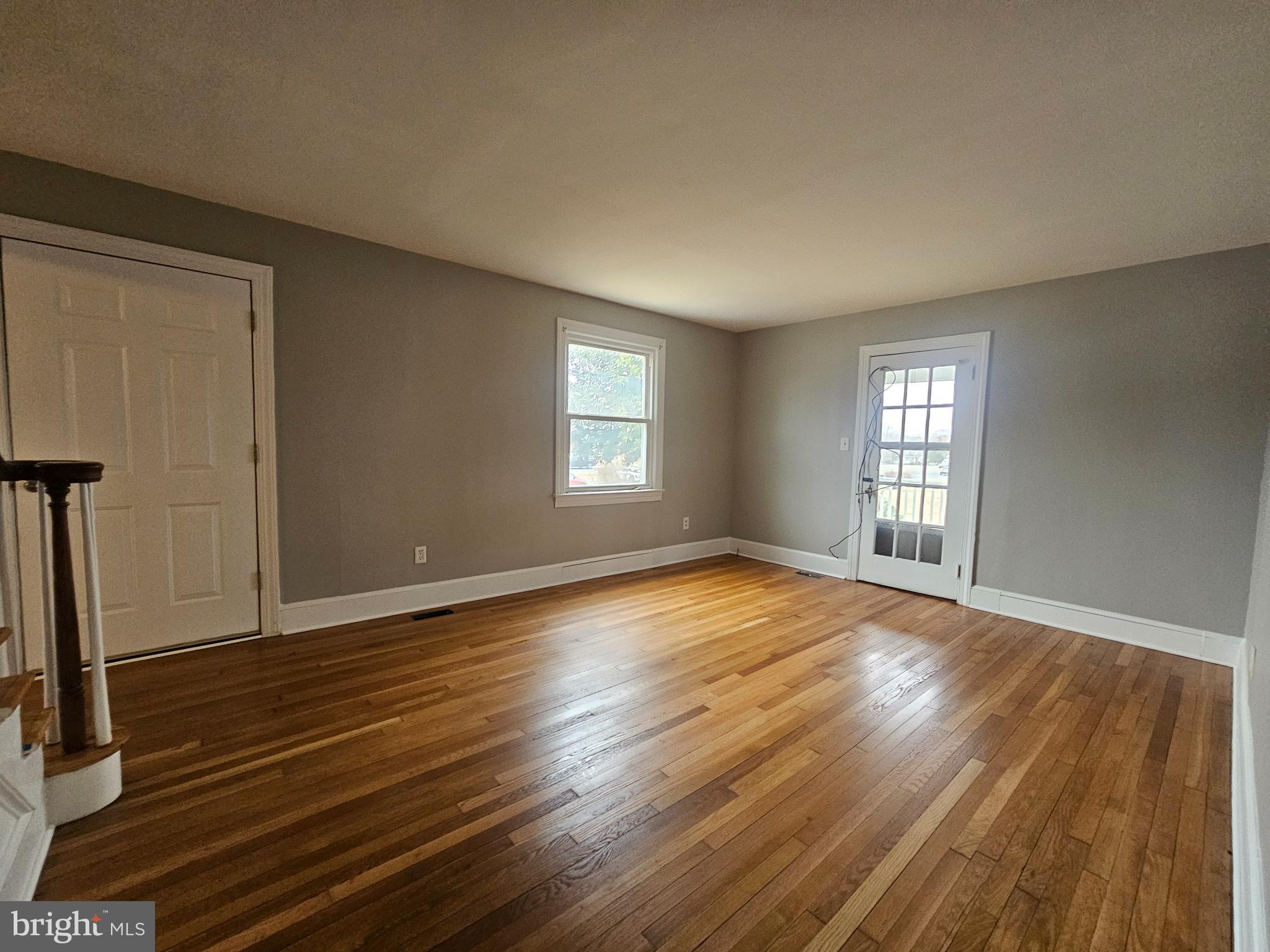 1431 Warrenton Road Fredericksburg, VA 22406 - Photo 4 of 25 an empty room with wooden floor and windows