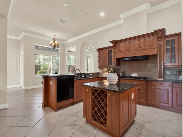 a kitchen with stainless steel appliances granite countertop a stove sink and cabinets