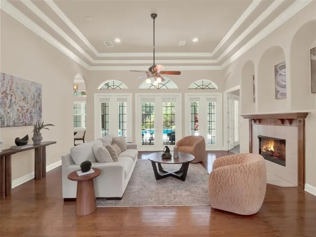 a living room with furniture and a chandelier