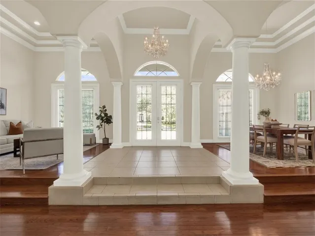 a view of a dining room with furniture and a chandelier
