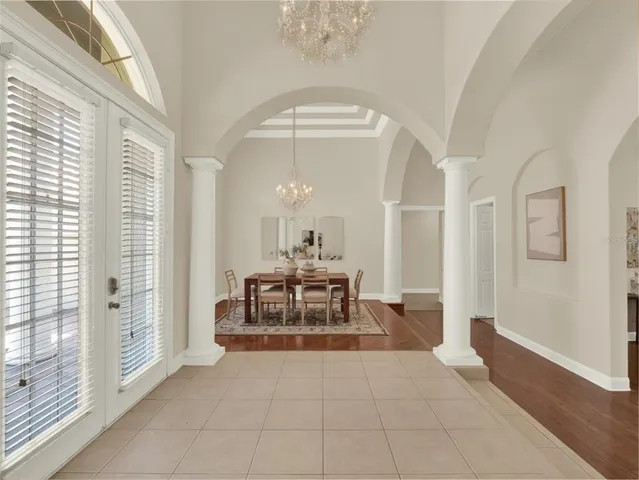 a living room with furniture a fireplace and a chandelier