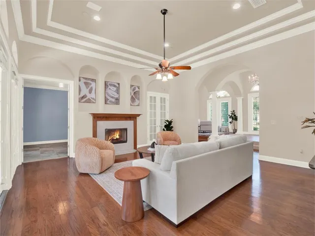 a living room with furniture and a chandelier