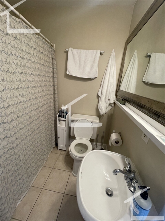 431 Faneuil Street, Unit 2A Boston, MA 02135 - Photo 8 of 8 a bathroom with a sink and a mirror