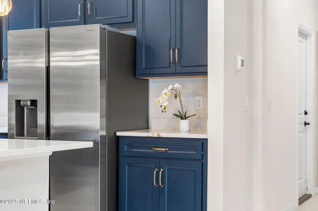 a kitchen with a refrigerator and cabinets