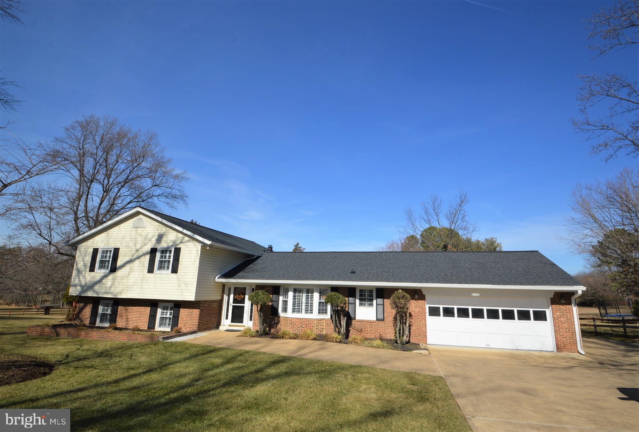 12614 Oxon Road Herndon, VA 20171 - Photo 1 of 71 a front view of a house with yard and garage