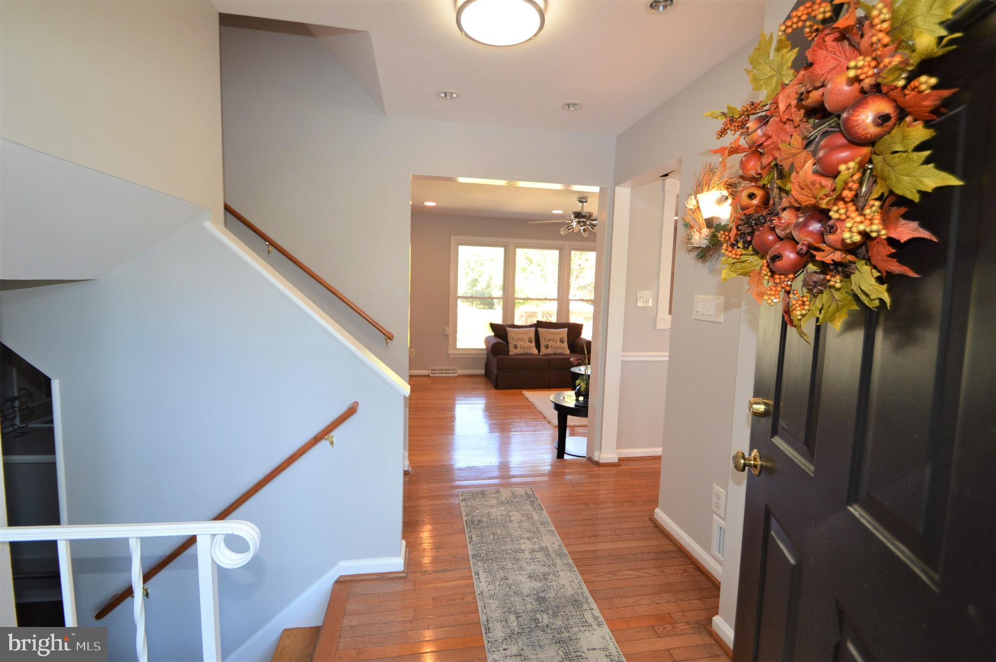 12614 Oxon Road Herndon, VA 20171 - Photo 24 of 71 a view of a hallway with wooden floor and staircase