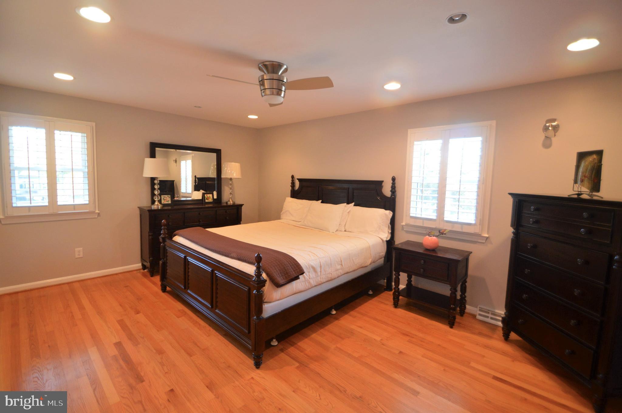 12614 Oxon Road Herndon, VA 20171 - Photo 44 of 71 a bedroom with a bed and wooden floor