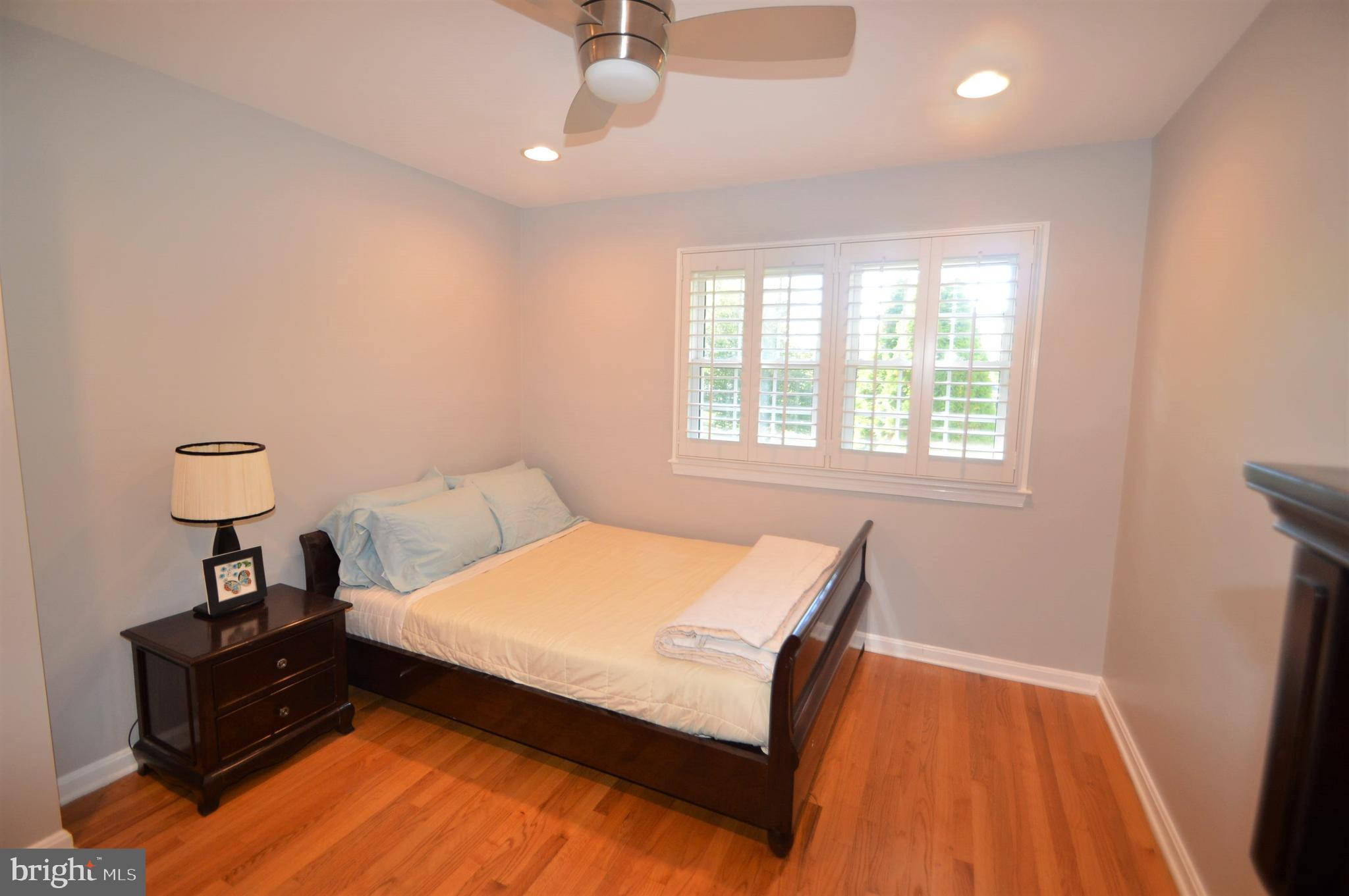 12614 Oxon Road Herndon, VA 20171 - Photo 50 of 71 a bedroom with a bed and wooden floor