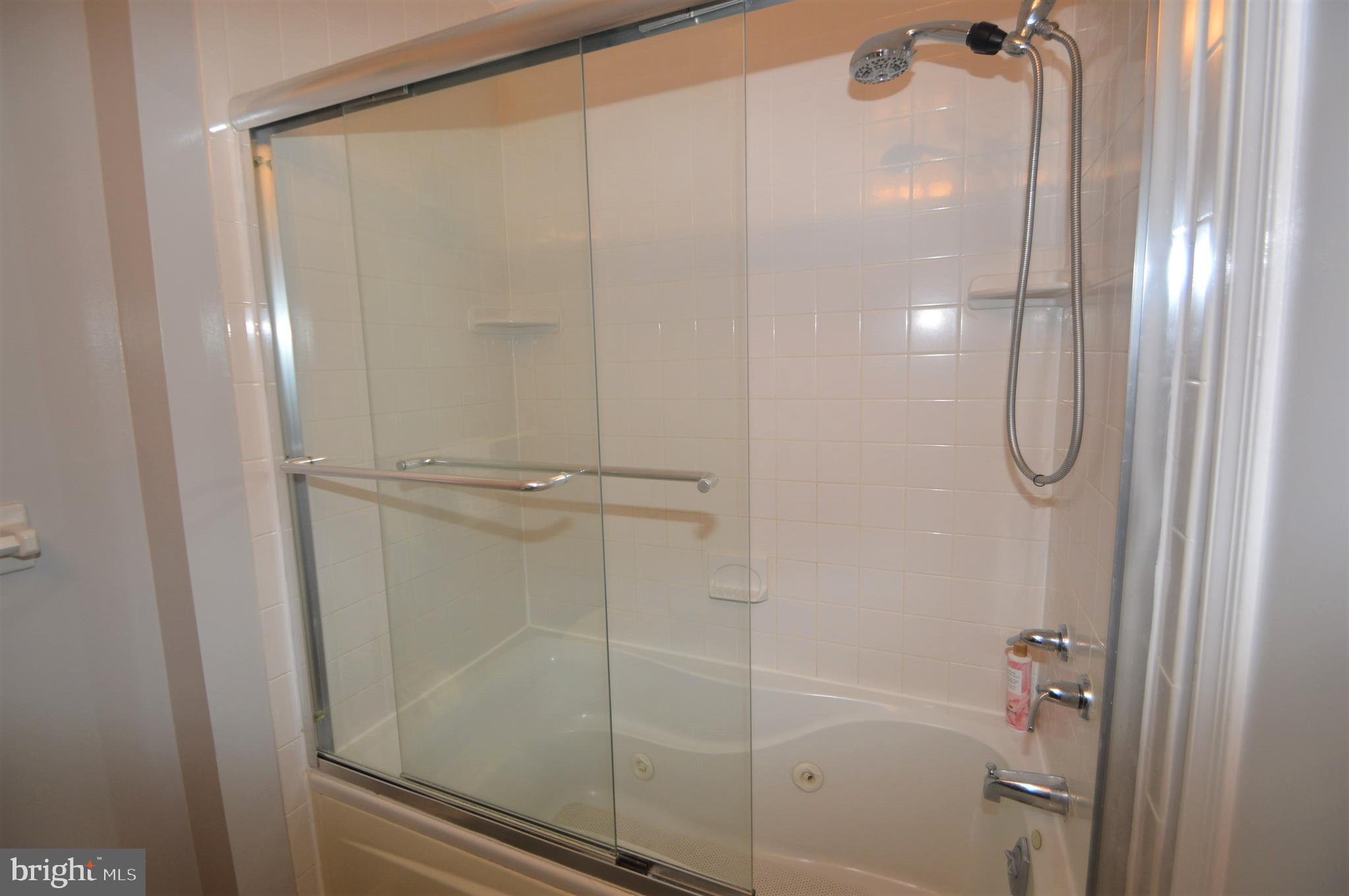 12614 Oxon Road Herndon, VA 20171 - Photo 51 of 71 a bathroom with a glass shower door