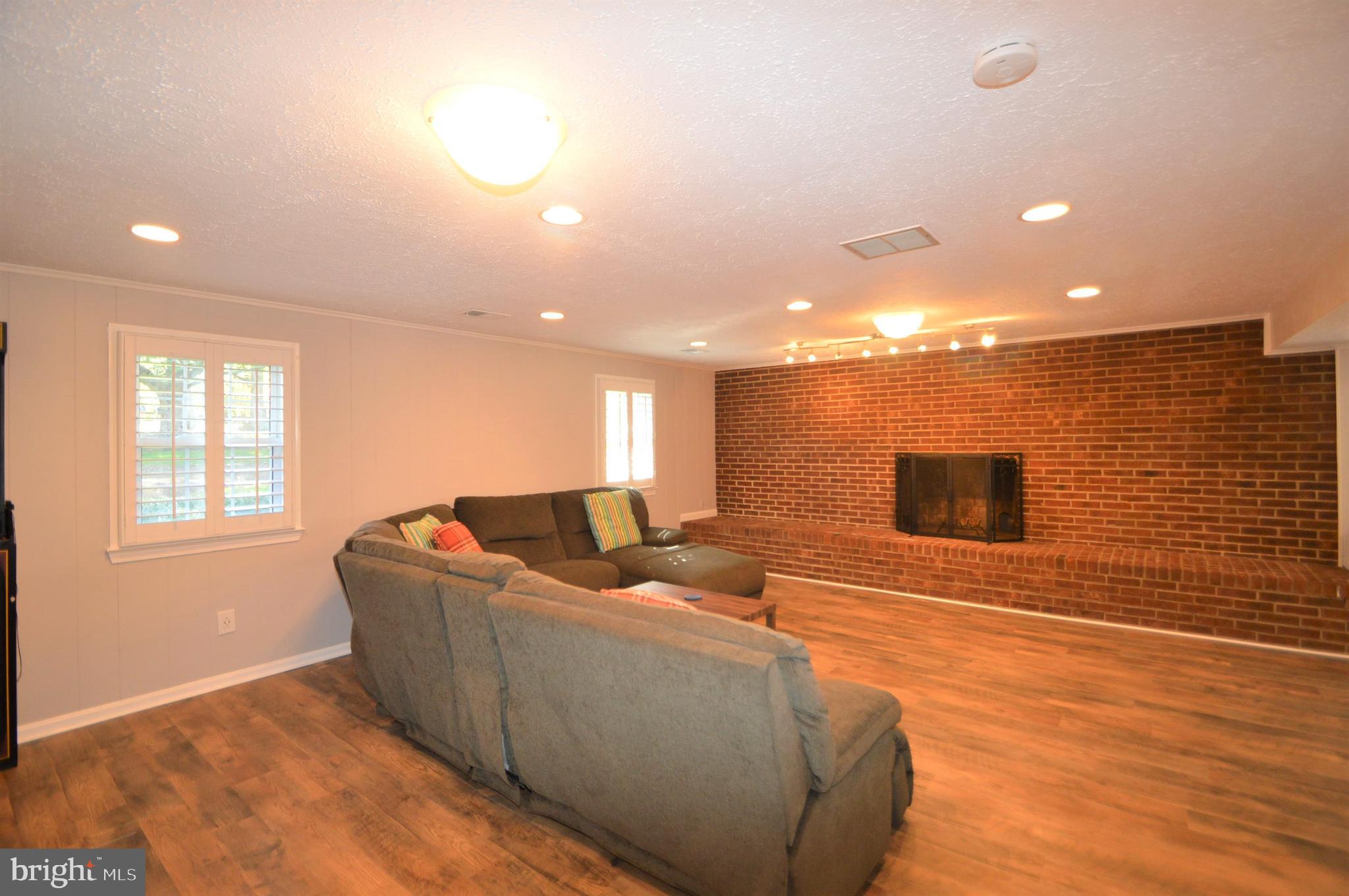 12614 Oxon Road Herndon, VA 20171 - Photo 53 of 71 a living room with couches and a flat screen tv