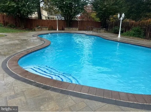 a view of swimming pool from a yard
