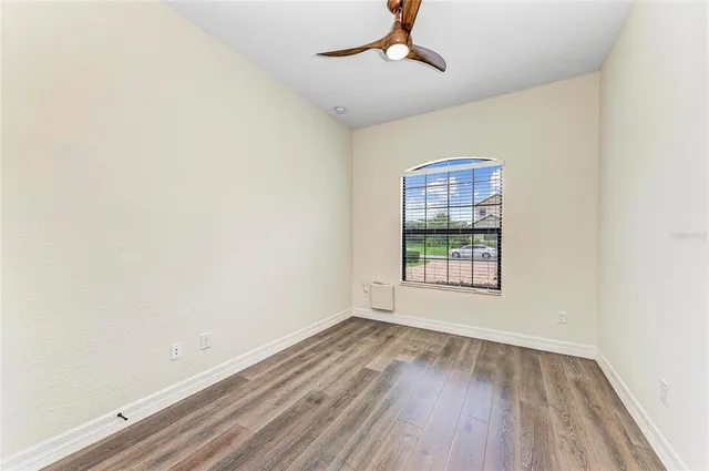 a bathroom with a granite countertop sink toilet a mirror a vanity and shower