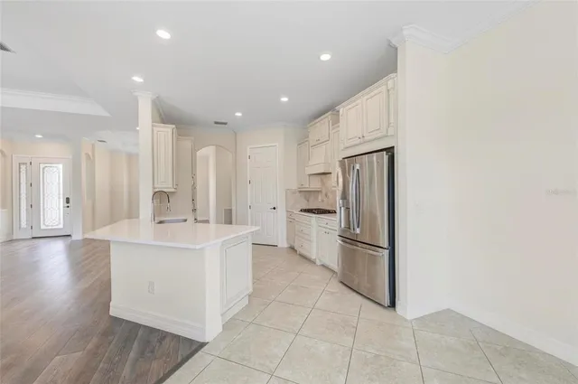 a kitchen with stainless steel appliances granite countertop a refrigerator and a sink