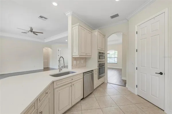 a large kitchen with stainless steel appliances granite countertop a stove and a sink