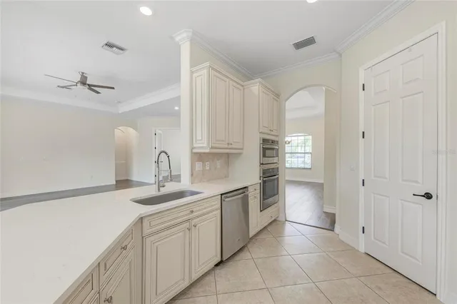 a large kitchen with stainless steel appliances granite countertop a stove and a sink