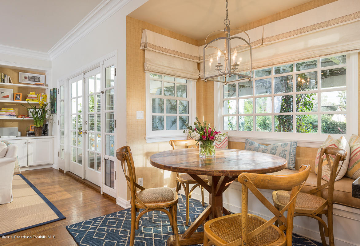 191 Sierra View Road Pasadena, CA 91105 - Photo 17 of 52 a dining room with wooden floor a chandelier a glass table and chairs