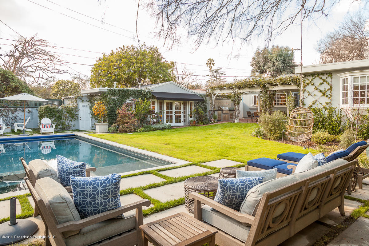 191 Sierra View Road Pasadena, CA 91105 - Photo 38 of 52 a view of a roof deck with couches chairs under an umbrella with large trees