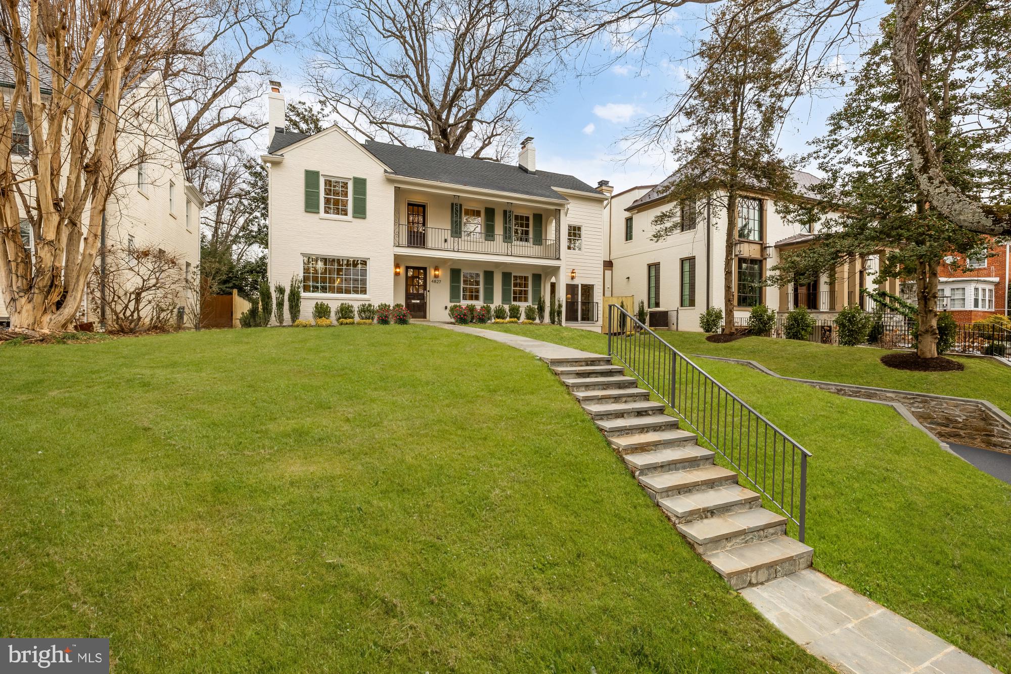 a front view of a building with a garden